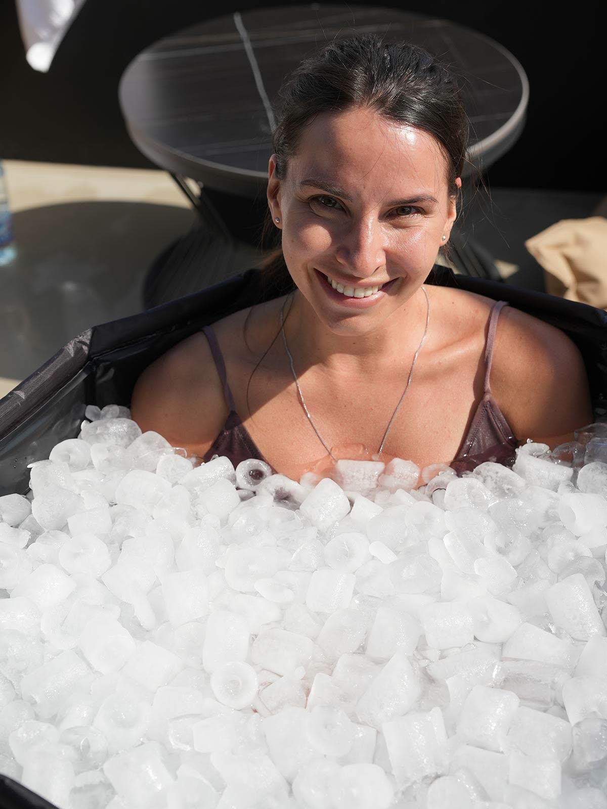 A guest smiling in an ice bath
